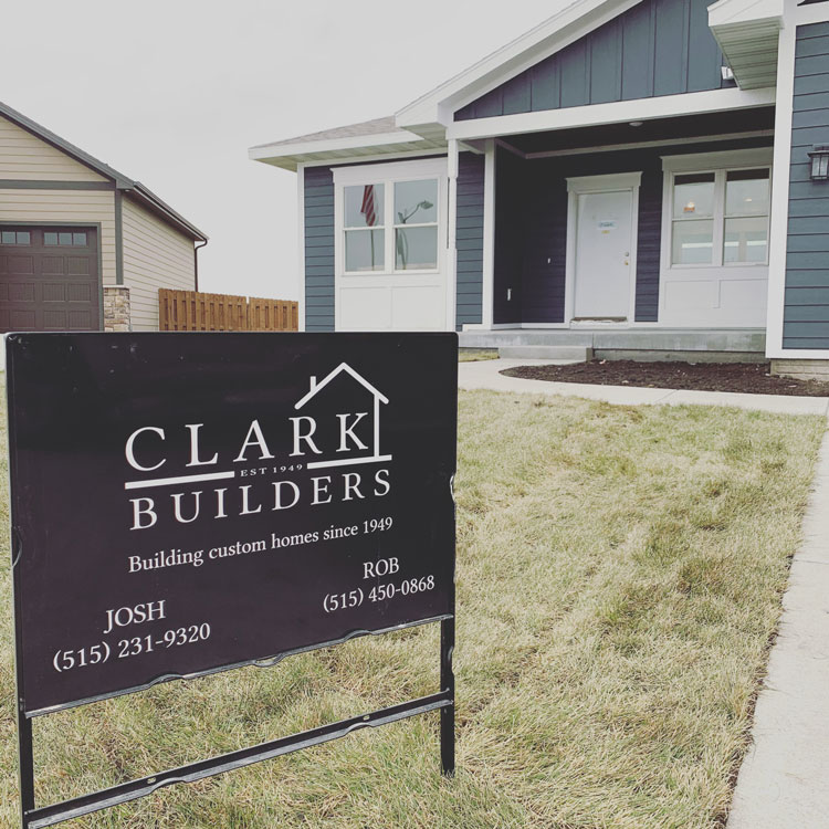 Sign in front of a house with the Clark Builders logo